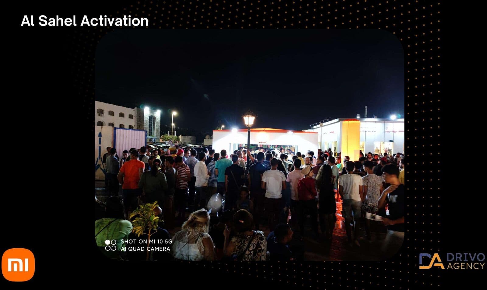 A branded tent structure and crowd at a night activation in Al Sahel