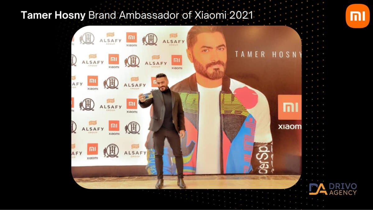 A press-wall event photo captioned 'Tamer Hosny, Brand Ambassador of Xiaomi 2021', co-branded with ALSAFY Group