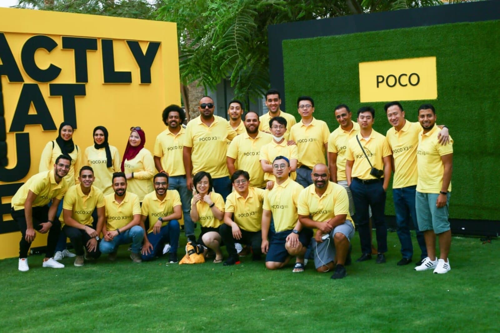 The POCO Egypt launch team, including regional Xiaomi/POCO colleagues, posed outdoors in matching yellow 'POCO X3' polos in front of branded signage