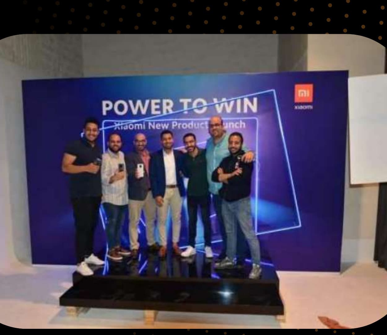 The Xiaomi Egypt team posing at a 'Power to Win' product launch backdrop during the COVID-19 online launch event