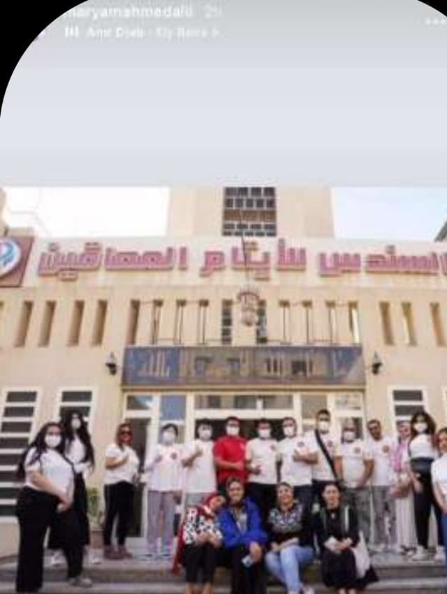 Xiaomi Egypt team members in branded shirts and masks outside an orphanage during a children's mental health CSR visit